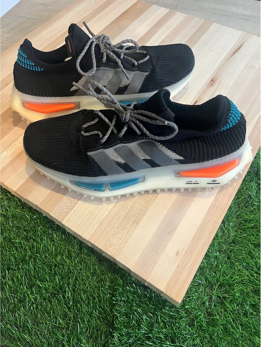Adidas Men's NMD S1 black sneakers with orange and blue sole